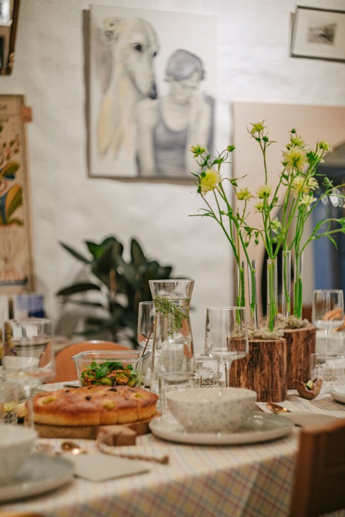 Friends share a warm dinner around a thoughtfully set home dining table.