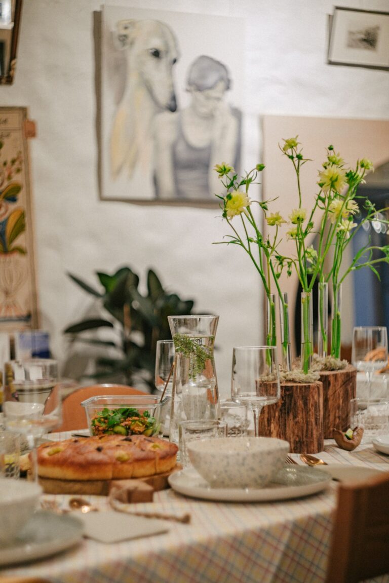 Friends share a warm dinner around a thoughtfully set home dining table.
